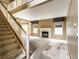 Spacious living room featuring a fireplace, staircase, and large windows at 7131 Topp Creek Ct, Indianapolis, IN 46214