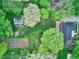 Aerial shot of the property featuring a yard, mature trees, and multiple buildings at 7180 W Sacramento Dr, Greenfield, IN 46140