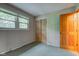 Bright bedroom with window, closet, and wooden door showcasing a simple design at 7180 W Sacramento Dr, Greenfield, IN 46140