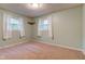 Neutral bedroom with carpeting, dual windows, and wall shelving at 7180 W Sacramento Dr, Greenfield, IN 46140