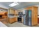 Modern kitchen featuring stainless steel appliances and wooden cabinetry with laminate floors at 7180 W Sacramento Dr, Greenfield, IN 46140