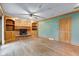 Bright living room featuring a brick fireplace, built-in shelving, and hardwood floors at 7180 W Sacramento Dr, Greenfield, IN 46140