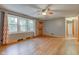 Bright living room with hardwood floors, large windows, and a view into other rooms at 7180 W Sacramento Dr, Greenfield, IN 46140