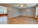 Spacious living room featuring hardwood floors, a ceiling fan, and bright, natural light at 7180 W Sacramento Dr, Greenfield, IN 46140