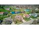 Aerial view shows homes, lawns, trees, a pond and neighborhood at 7634 Pennycroft Dr, Indianapolis, IN 46236