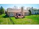 Aerial view of backyard with deck, chimney, table, chairs, grill and fenced in yard at 7634 Pennycroft Dr, Indianapolis, IN 46236