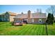Aerial view of backyard with deck, chimney, table, chairs, grill and fenced in yard at 7634 Pennycroft Dr, Indianapolis, IN 46236