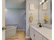 Bathroom featuring a soaking tub, standalone shower, and a single sink vanity with a light gray color scheme at 7634 Pennycroft Dr, Indianapolis, IN 46236