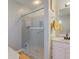 Bathroom with a sliding glass shower, a mirror, a white sink and towels hanging nearby at 7634 Pennycroft Dr, Indianapolis, IN 46236