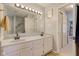 Bathroom with double vanity sinks, modern fixtures, and ample lighting at 7634 Pennycroft Dr, Indianapolis, IN 46236