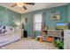 Brightly-lit bedroom decorated with space decor, a white bed and white organization shelves at 7634 Pennycroft Dr, Indianapolis, IN 46236