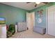 bedroom with gray dresser, storage bench, green walls and fun wall decor at 7634 Pennycroft Dr, Indianapolis, IN 46236