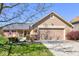 Charming home featuring a well-maintained lawn, brick accents, and a two-car garage at 7634 Pennycroft Dr, Indianapolis, IN 46236