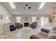 Bright living room features a fireplace, skylights, and an open floor plan at 7634 Pennycroft Dr, Indianapolis, IN 46236