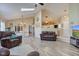 Open-concept layout showcasing the living room's fireplace and connectivity to the dining and kitchen areas at 7634 Pennycroft Dr, Indianapolis, IN 46236