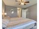Inviting main bedroom featuring a ceiling fan, soft lighting, and neutral tones at 7634 Pennycroft Dr, Indianapolis, IN 46236