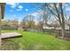 Green backyard with a wooden deck, shed, and privacy fence, perfect for outdoor enjoyment at 7702 Dornock Dr, Indianapolis, IN 46237