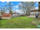 View of the backyard featuring a shed, the sunroom, the home, and privacy fence at 7702 Dornock Dr, Indianapolis, IN 46237