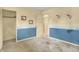 Bedroom with nautical themed wallpaper, closet and light from adjacent room at 7702 Dornock Dr, Indianapolis, IN 46237