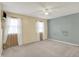 Bedroom featuring two large windows with sheer white curtains and carpeted floors at 7702 Dornock Dr, Indianapolis, IN 46237
