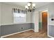 Neutral dining room with bright window, wood floors and views of the hallway at 7702 Dornock Dr, Indianapolis, IN 46237