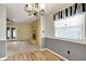 Light dining room with wood floors, and views to the backyard through a bright window at 7702 Dornock Dr, Indianapolis, IN 46237