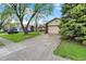 Well-kept home with a spacious driveway, attached garage, and mature landscaping at 7702 Dornock Dr, Indianapolis, IN 46237