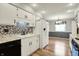 Bright kitchen featuring white cabinets, granite countertops, and stainless steel appliances at 7702 Dornock Dr, Indianapolis, IN 46237