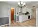 Bright eat-in kitchen with white cabinets, granite countertops, and stainless steel appliances at 7702 Dornock Dr, Indianapolis, IN 46237