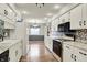 Bright kitchen featuring white cabinets, granite countertops, and stainless steel appliances at 7702 Dornock Dr, Indianapolis, IN 46237