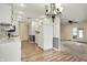 Bright kitchen features white cabinets, stainless appliances and hardwood floors at 7702 Dornock Dr, Indianapolis, IN 46237