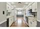 Bright kitchen featuring white cabinets, granite countertops, and stainless steel appliances at 7702 Dornock Dr, Indianapolis, IN 46237