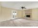 Open living room with french doors and a cozy brick fireplace at 7702 Dornock Dr, Indianapolis, IN 46237