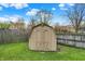 Backyard shed with double doors and a fenced yard at 7702 Dornock Dr, Indianapolis, IN 46237