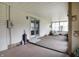 Spacious sunroom with carpet flooring, lots of light, and a door to the backyard at 7702 Dornock Dr, Indianapolis, IN 46237