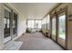 Bright sunroom featuring neutral walls, carpet flooring, and multiple windows allowing ample natural light at 7702 Dornock Dr, Indianapolis, IN 46237