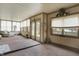 An airy sunroom featuring carpet flooring, lots of light, cozy seating and decorative accents at 7702 Dornock Dr, Indianapolis, IN 46237