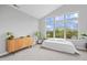 Airy bedroom showcasing a large window, vaulted ceiling, modern dresser, minimalist decor, and lots of natural light at 8180 E 116Th St, Fishers, IN 46038