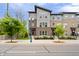Charming townhouse complex with modern design and brick accents, enhanced by decorative street lighting in daytime at 8180 E 116Th St, Fishers, IN 46038