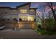 Townhome exterior view at dusk with private balconies and attached garages at 8180 E 116Th St, Fishers, IN 46038
