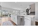 Bright kitchen boasts stainless steel appliances, white cabinetry, quartz countertops, and a seamless transition to the outdoor living area at 8180 E 116Th St, Fishers, IN 46038