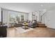 Inviting living room with a comfortable gray sofa, hardwood floors, and staircase leading to the upper level at 8180 E 116Th St, Fishers, IN 46038