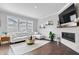 Bright living room features a white sectional sofa, modern fireplace, and large windows with great natural light at 8180 E 116Th St, Fishers, IN 46038