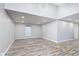 Spacious basement with recessed lighting, wood-look floors, gray walls, and a window letting in natural light at 838 N Tacoma Ave, Indianapolis, IN 46201