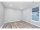 Bright bedroom featuring recessed lights, wood-look floors, light gray walls, and a window letting in natural light at 838 N Tacoma Ave, Indianapolis, IN 46201
