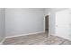 This bedroom features light gray walls, unique wood-look flooring, and a door to the closet at 838 N Tacoma Ave, Indianapolis, IN 46201