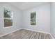 Well-lit bedroom with dual windows, featuring neutral walls and modern flooring at 838 N Tacoma Ave, Indianapolis, IN 46201