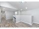 Hallway featuring recessed lights, wood-look floors, neutral walls, window, and staircase at 838 N Tacoma Ave, Indianapolis, IN 46201