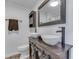 Stylish bathroom featuring double sinks, a rustic wood vanity, and modern fixtures at 91 Crestview Dr, Greenwood, IN 46143