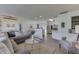 Bright and airy living room featuring a large gray sofa, a glass coffee table, and wood-look flooring at 91 Crestview Dr, Greenwood, IN 46143